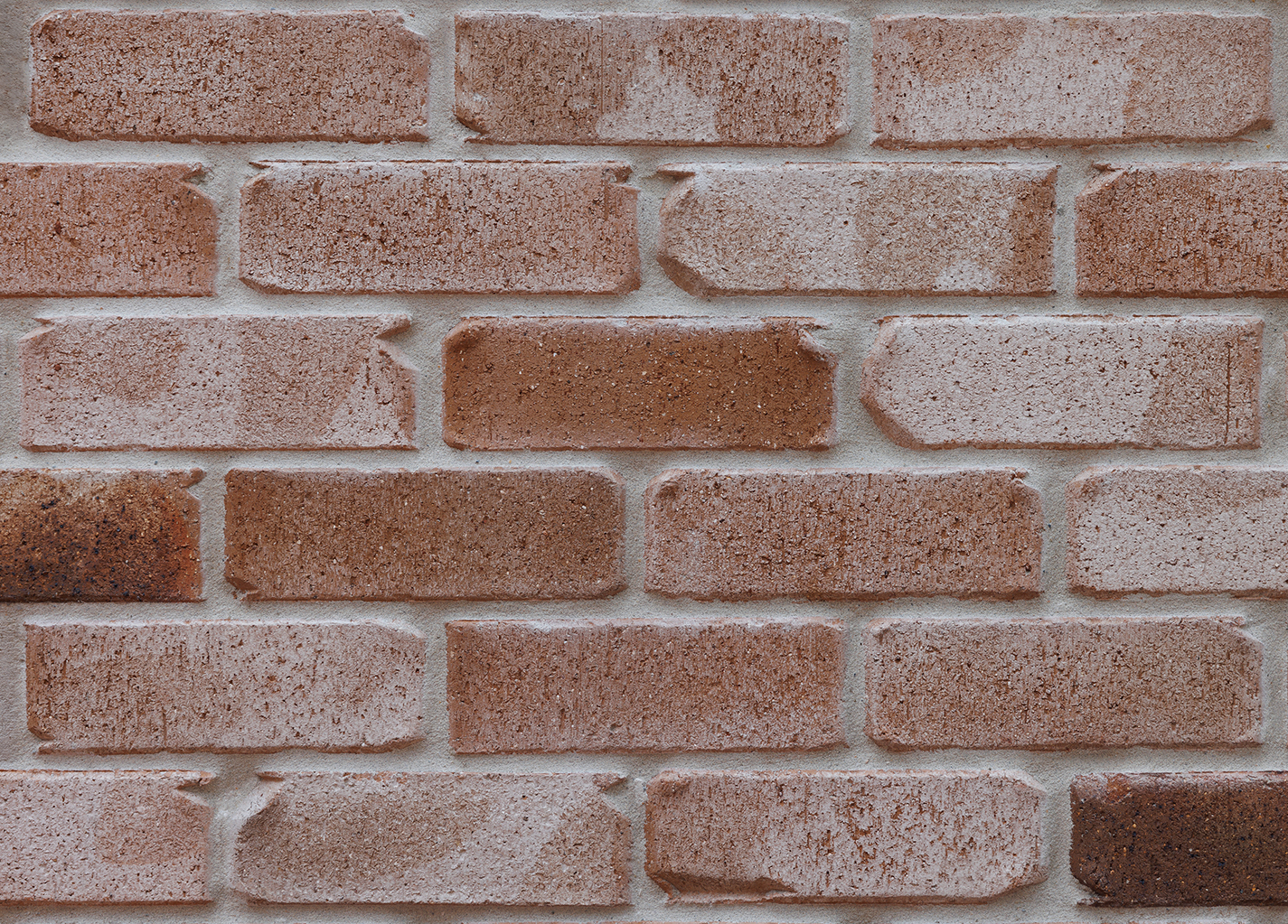 Close-up of a brick wall with varying shades of brown bricks.