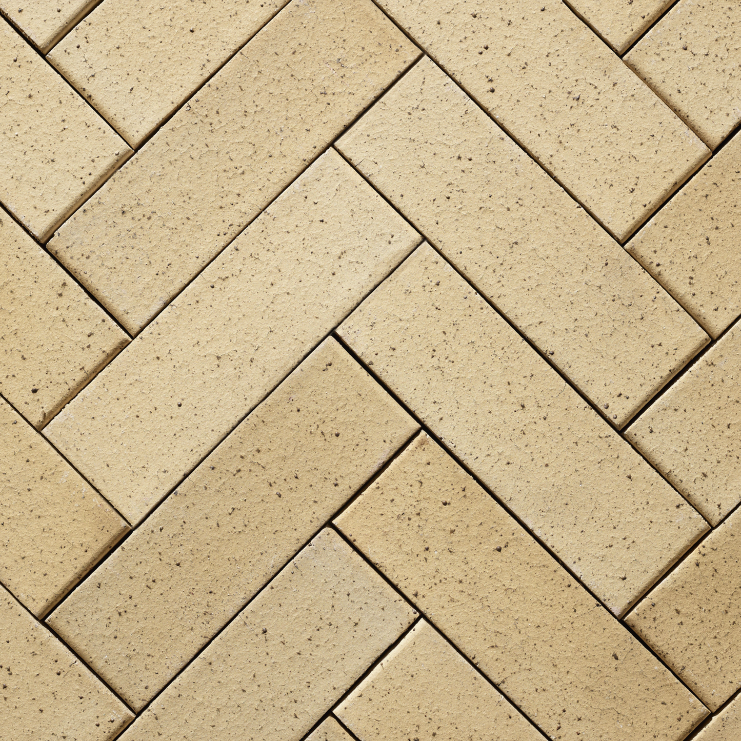 Pattern of beige bricks arranged in a herringbone design