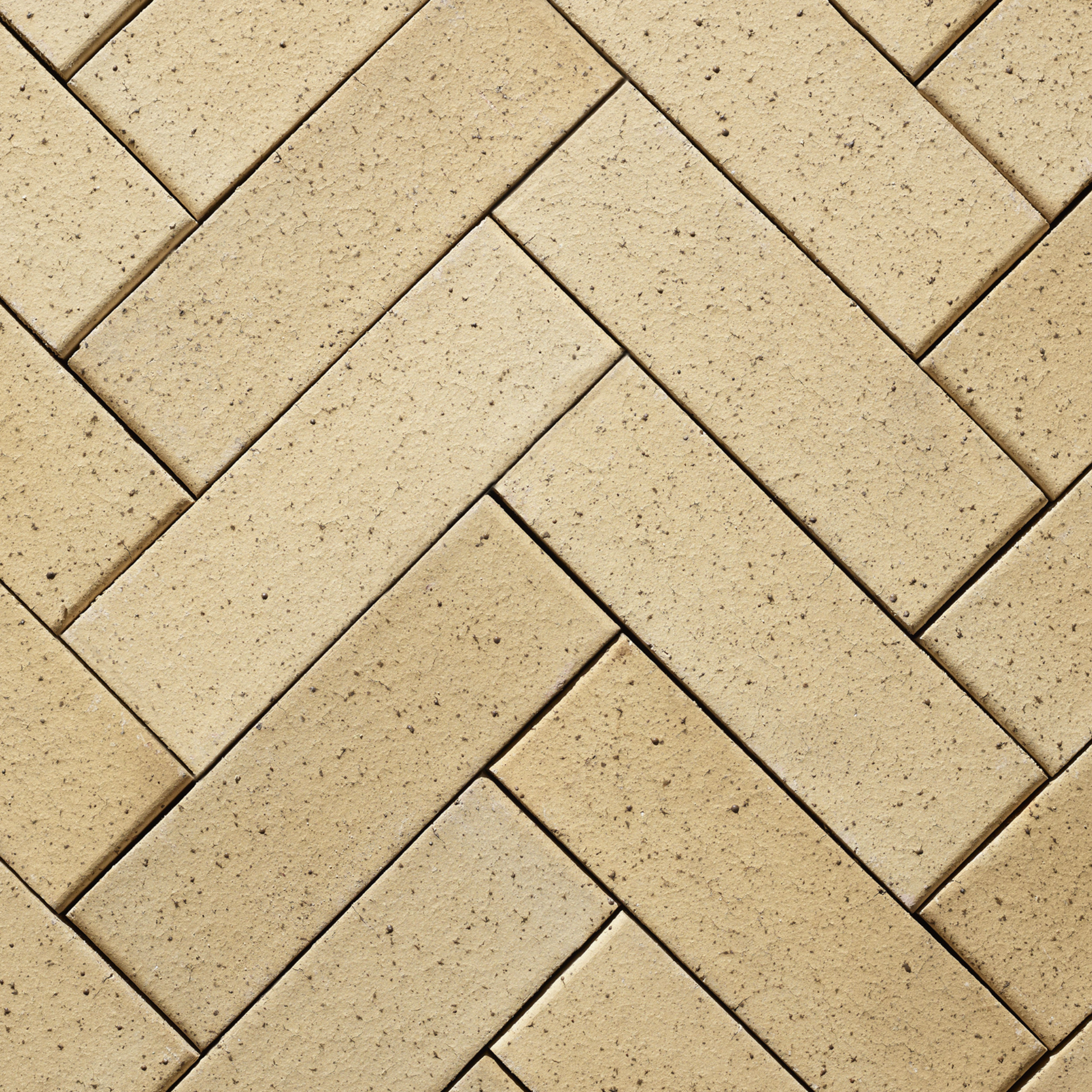 Pattern of beige bricks arranged in a herringbone design