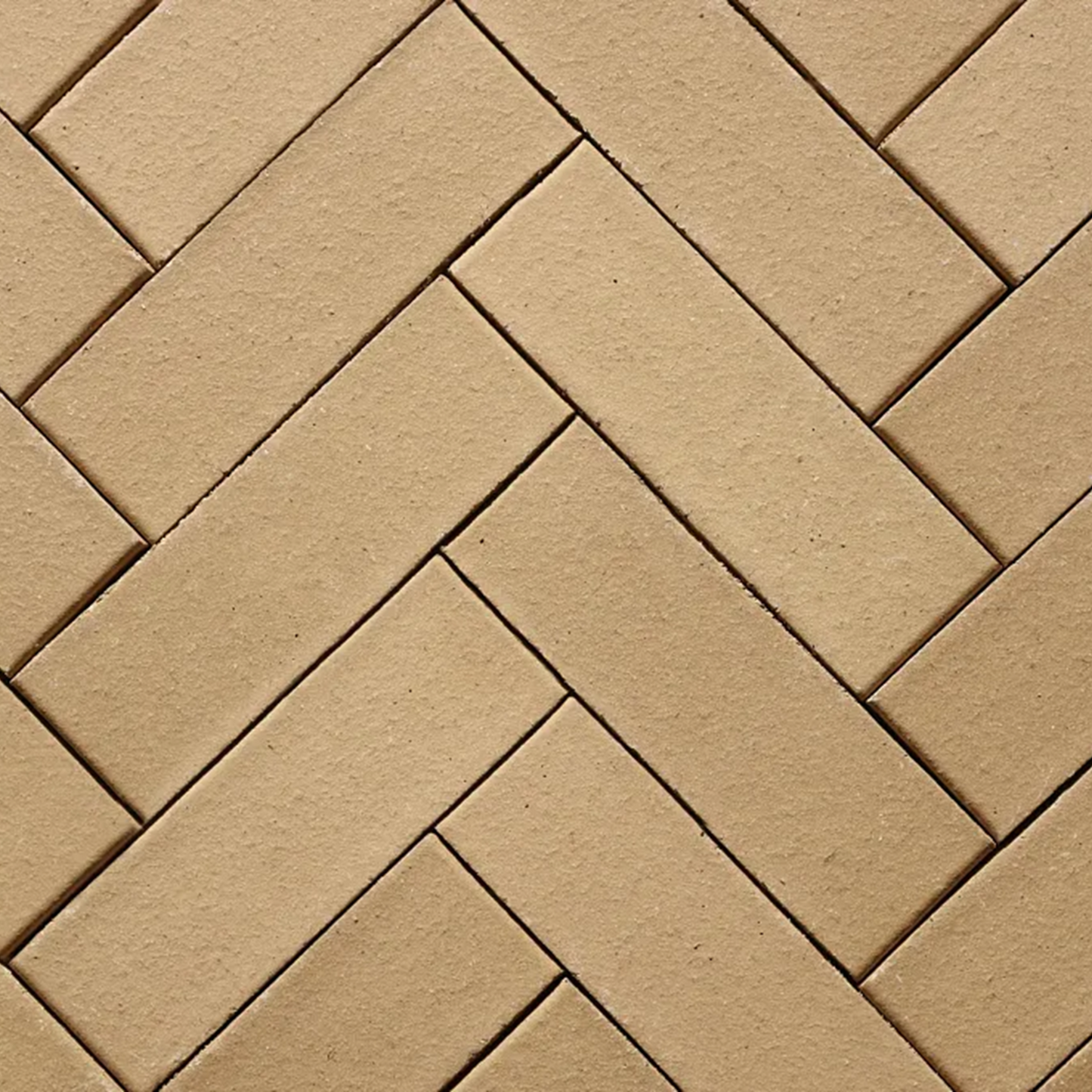 Pattern of beige bricks arranged in a herringbone design