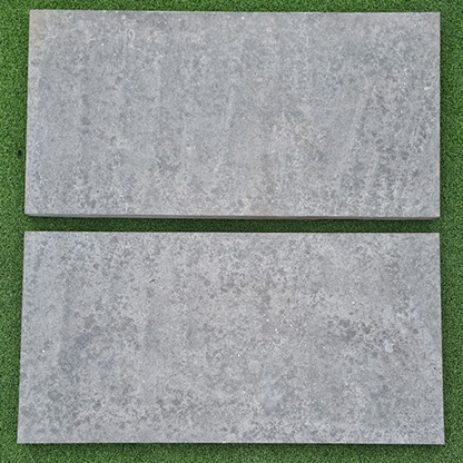 Two gray tiles on a green background