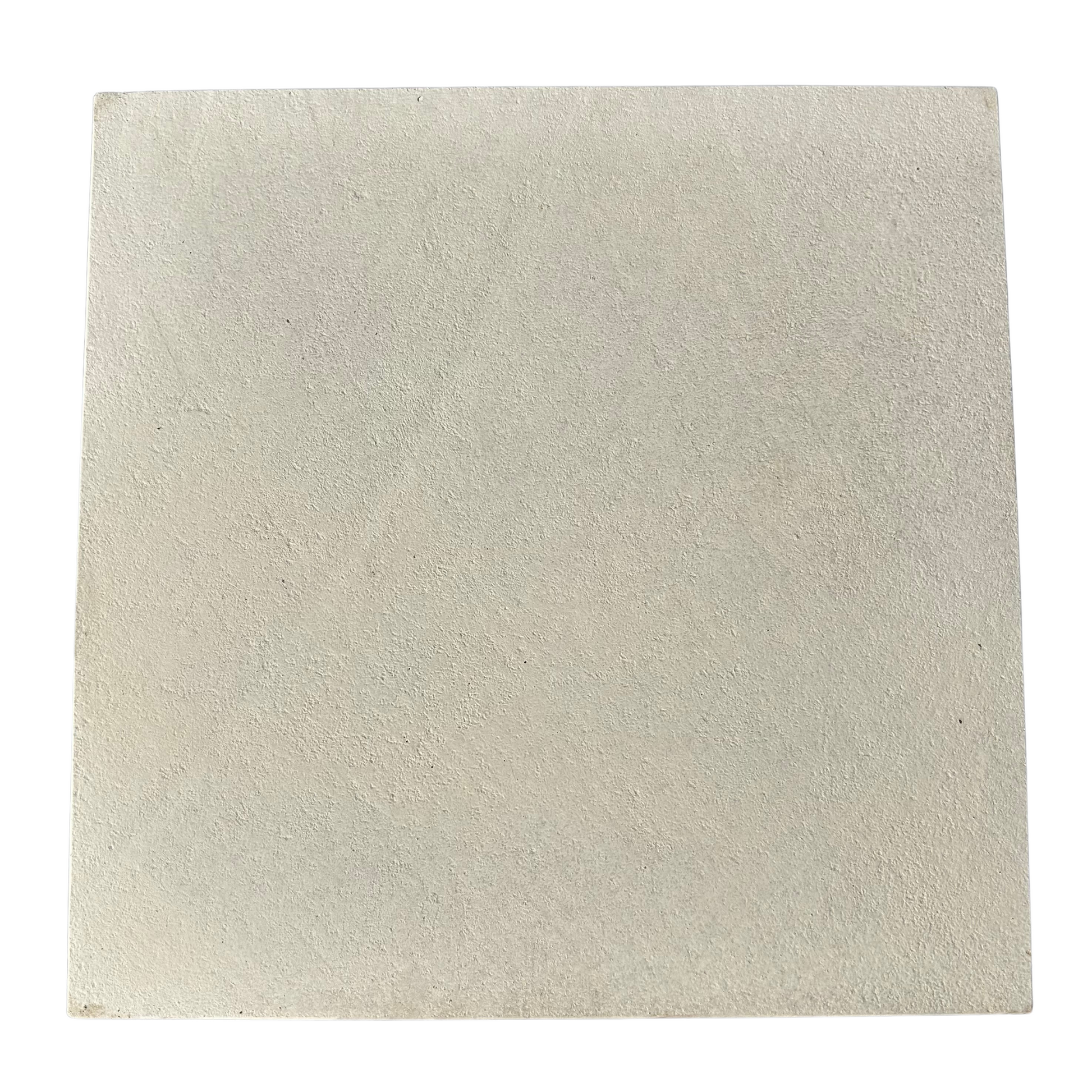 Beige square tile with a textured surface on a white background